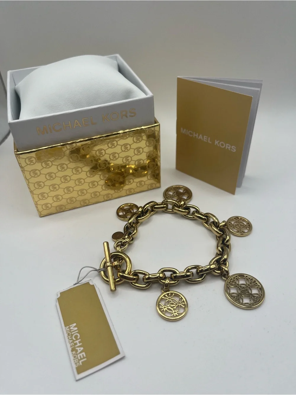 Michael Kors Gold Tone Charm Toggle Bracelet MK Logo Medallion NWT in Box